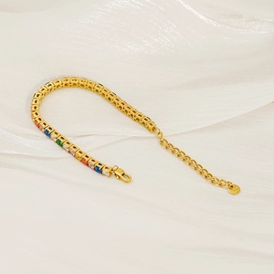 Detail of colorful cubic zirconia tennis bracelet on white silk with lobster clasp