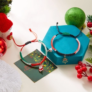Detail of Christmas magnetic braided bracelets with Santa and Christmas tree charms
