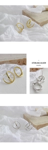 Macro shot of minimalist S925 sterling silver double hoop earrings in gold and silver