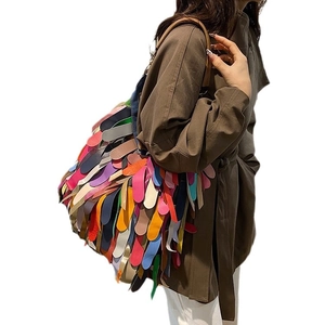 Bohemian multicolored snakeskin fringe shoulder bag with layered faux leather patches