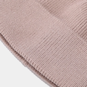 Macro shot of grey-pink rib-knit fabric texture on men's winter hat and mask set