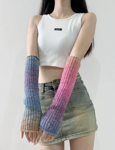Detail of gradient rainbow wool arm warmers showing the knit texture and thumb hole