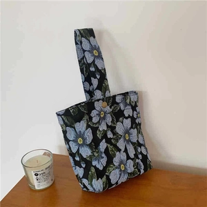 Vintage floral jacquard underarm bag with blue flower pattern and metal button closure