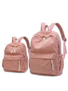 Set of large and small pink corduroy backpacks with vintage texture and zipper detail