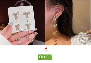Detailed view of elegant gold bow tassel earrings with sparkling rhinestones and S925 silver pins