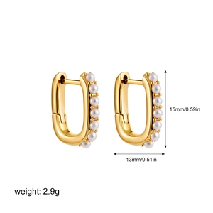Detail view of gold U-shaped earrings with pearls showing dimensions 15mm by 13mm