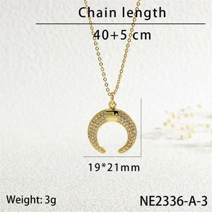 Detail view of a gold crescent moon pendant with micro-inlaid white cubic zirconia