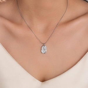 Silver tulip pendant necklace on snake chain featuring an oval embossed floral design
