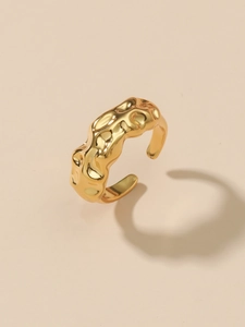 Detailed close-up of a gold-plated brass ring featuring a unique pleated texture and open design