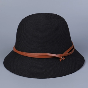 Detailed view of the brown leather buckle and fine knit texture on a black sun hat