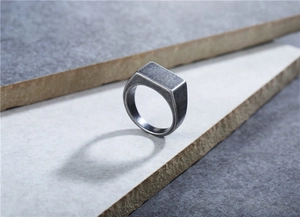 Detail of vintage rectangular signet ring with brushed titanium steel industrial finish