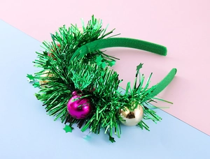 Detail of Christmas headband with colorful sequin balls and green tinsel stars