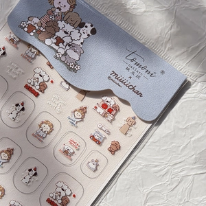 Close-up of cartoon dog and girl nail art stickers with various cute decorative motifs