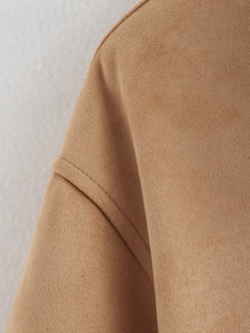 Detailed close-up showing the premium suede fabric texture and stitching on the camel jacket