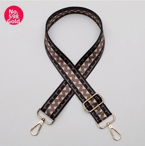 Detail of adjustable polyester strap with brown zigzag pattern and gold metal hooks