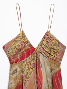 Detailed view of yellow floral midi dress with V-neckline, drawstring chest, and thin straps