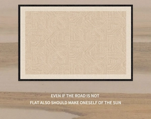 Detailed view of beige geometric woven carpet with textured patterns and black fabric edges