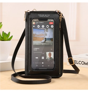 Detail of crossbody phone bag featuring a transparent touch screen window and gold hardware