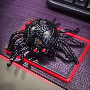 Halloween spider sensory stress ball toy with colorful liquid bubbles and red eyes