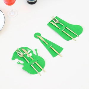 Felt Christmas cutlery holder set with snowman, sock and hat designs on a white table