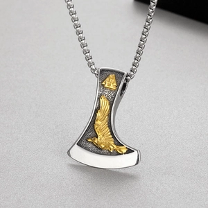 Détail du pendentif hache viking avec corbeau doré et symbole Valknut sur métal argenté