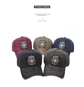 Detailed view of washed cotton baseball caps in multiple colors with Marine embroidery