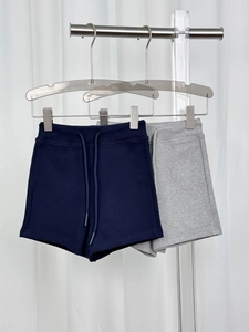 Detail of high-waisted gym shorts in dark blue and grey with drawstring elastic waist