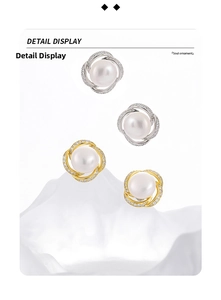 Detailed view of silver and gold pearl earrings with sparkling rhinestone swirl design