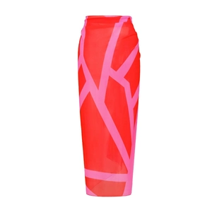 Detail of red and pink geometric pattern on a lightweight beach sarong skirt