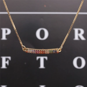 Detail of colorful cubic zirconia horizontally set on a delicate golden box chain