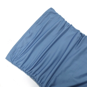 Detailed macro view of the blue ruched fabric texture on this beach mini dress