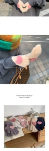 Detail of plush knit gloves with heart patterns and soft faux mink fur texture
