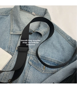 Adjustable black nylon shoulder strap detail on casual denim jacket background