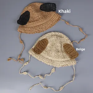 Detail of hand-woven straw hats with animal ears, wavy brims and adjustable chin straps