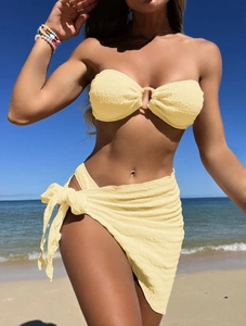 Detail of yellow textured bandeau bikini top with O-ring and matching beach sarong