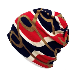 Detail of multi-color knitted beanie featuring abstract chain patterns and ribbed texture