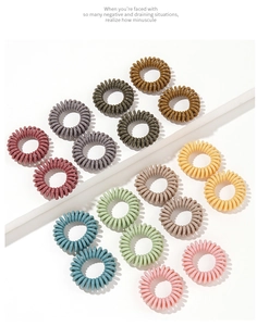 Detailed view of colorful spiral telephone cord hair ties in assorted matte pastel shades