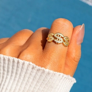 Hip hop style gold dollar sign ring with sparkling crystals for a trendy luxury streetwear look