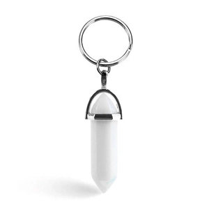 Hexagonal white crystal stone pillar keychain with silver metal holder on white background