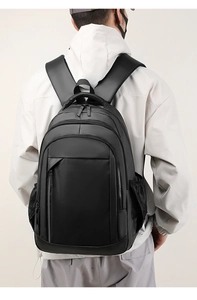 Detailed back view of a large black waterproof backpack with adjustable padded straps