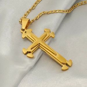 Collana a croce multistrato in acciaio inossidabile dorato su sfondo di seta