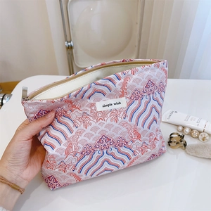 Detail of Chinese style wave pattern makeup bag with woven fabric and metal zipper
