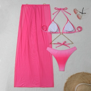Detail of pink gradient bikini with gold chain accents and sheer mesh beach sarong