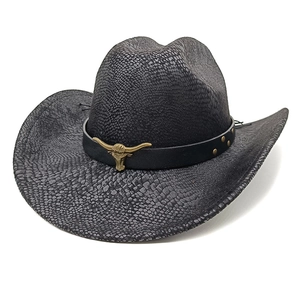 Detail of snake skin texture cowboy hat with bull head metal buckle and bronze rivets