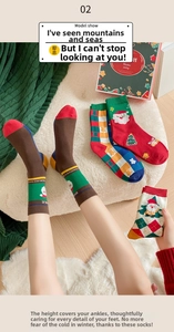 Detail of Christmas mid-tube socks featuring Santa and tree patterns in a gift box