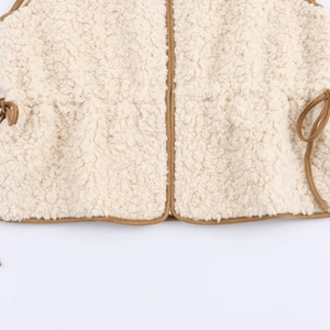 Fashionable round neck lamb wool vest in cream with adjustable waist and brown suede trim