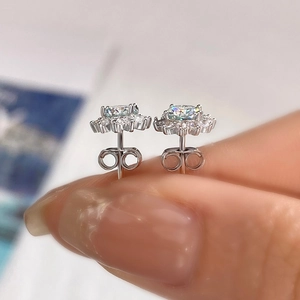 Macro view of 925 silver sunflower stud earrings with round moissanite and claw setting