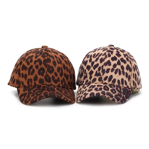 Detail view of leopard print baseball caps in dark brown and light beige canvas patterns