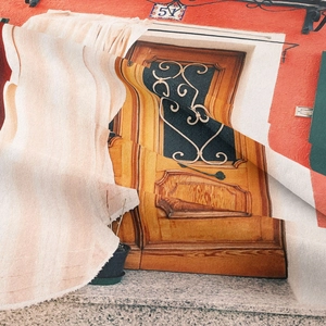 Detailed texture of bohemian tapestry showing red wall and vintage door pattern