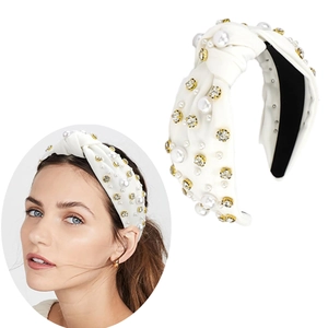 Detailed view of a white knotted headband featuring elegant pearls and sparkling rhinestones